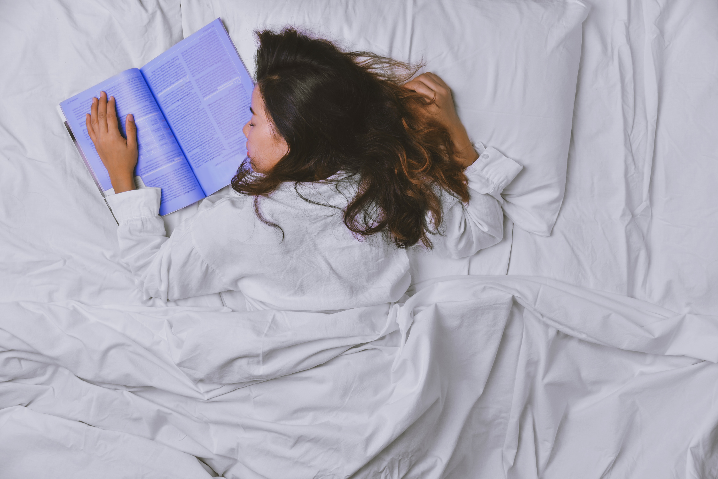 A women who fell asleep while reading a book